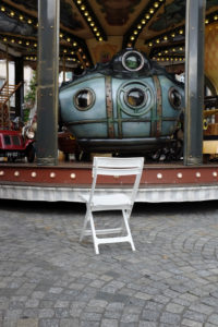Chair in front of a carousel Chair in front of a carousel